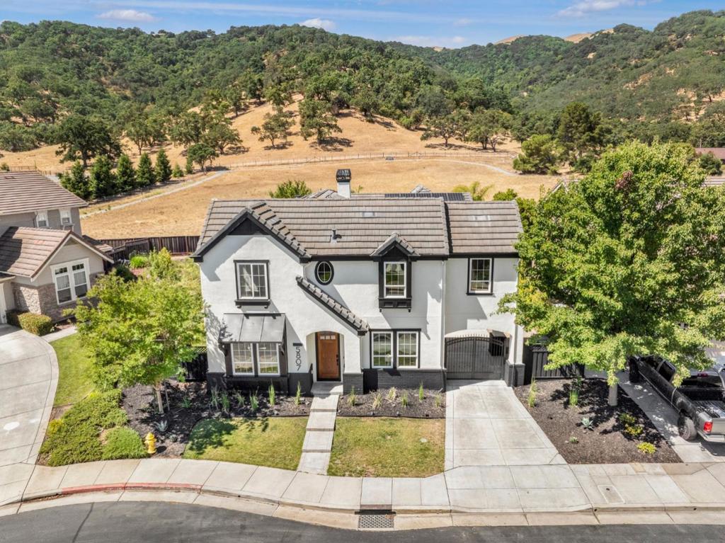 Welcome to 5807 Casita Way, a rare luxury home in the private and peaceful Mesa Ridge community, an exclusive enclave of just 73 homes nestled in the scenic Gilroy foothills. This upgraded Plan 3 by Hovnanian Builders features 3,334 sq ft, 5 BD, 3.5 BA, and a spacious loft ideal for a home office, media room, or play space. A downstairs bedroom with adjacent half bath offers great flexibility with potentials to convert it into a 4th full bathroom and a 6th bedroom, ideal for guests or multigenerational living. Designer upgrades include: Wide-plank luxury vinyl flooring throughout, Custom quartzite countertops in kitchen and baths, Modern fireplace with custom tile surround, Bright white cabinetry with designer hardware, Stainless steel appliances + walk-in pantry, Waterfall-edge kitchen island, Upgraded lighting and fixtures, Refreshed bathrooms with quartzite vanities and framed mirrors, Fresh interior paint and finishes, Whole-house Honeywell generator, Full solar on NEM2 (leased). Enjoy a private gated courtyard and a backyard with stunning foothill viewsperfect for morning coffee or evening wine. Mesa Ridge offers two parks, BBQ/picnic areas, and easy access to trails, wineries, shopping, and top-rated schools.