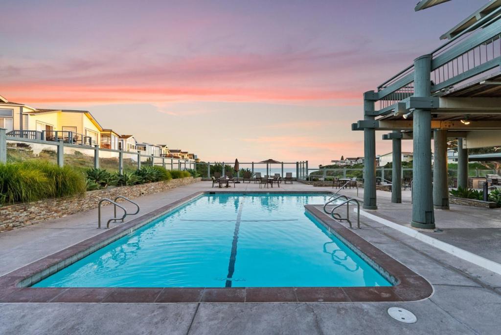 Enjoy the Beach Life in this beautifully renovated 3 bedroom/2 bath coastal delight! This open light-filled floor plan is spacious & functional. Sleek Quartz counters, stainless appliances & walk-in pantry create a modernized kitchen. Separate dining area with built-in buffet is perfect for entertaining & gatherings. Remodeled primary & hall bathrooms, LVP flooring & newer paint update the interior. Laundry area with extra cabinet space! Two generous lighted and locking storage sheds, a BBQ area & private rear patio for a nightcap under the stars. Nearby path leads directly to the club house with incredible ocean views where you can host your special events! Monthly space rent is $3811 which includes resort amenities: heated pool, hot tub, sauna, gym, outdoor kitchen, & fire pit. Just steps to the beach & tide pools. Nearby biking & hiking trails to Seymour Marine Center & Wilder Ranch. Next to Natural Bridges State Beach & Monarch Trail, UCSC Bus. Centrally located-drivable to Los Gatos/Bay Area, Santa Cruz Beaches, Monterey/Carmel. Sellers are motivated - bring offers!