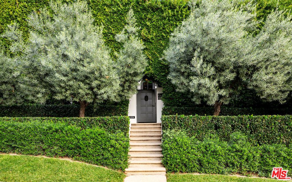 Welcome to Casa Oliva. Set behind mature hedging and gates, lies this tastefully redone Contemporary Spanish on a street-to-street lot off the Sunset Strip. Landscape design by world famous Scott Shrader. Hand-forged glass steel doors welcome you to this private sanctuary ideal for entertaining on a grand or intimate scale. The main level features a step-down living room with antique stone mantle and fireplace overlooking the lush landscaping with bubbling fountain. Game room or library with Venetian plaster walls + a separate office with built-in shelving and sitting area. Large great room with custom eat-in kitchen with expansive marble island, Wolf-Range and double ovens, Sub-Zero Fridge and Miele dishwasher. Family room features a 13th Century French mantle fireplace, surrounded on two sides by steel French doors. Powder room + guest suite completes the first floor. Sweeping 2-story curved staircase leads you to the second floor. The primary suite features a fireplace with sitting area, balcony and dual spa-like bathrooms with two large custom closets. Two additional bedroom suites, each with balconies. Backyard rivals some of the finest hotels in the world. Featuring an expansive veranda with seating for 16+. The outdoor kitchen with bar and BBQ has a restaurant grade pizza oven. Sparkling pool, spa and multiple seating areas with fireplace, exquisite outdoor lighting and hidden shower. Separate guest house. Two-car garage with direct access, motor court plus an additional gated carport. Smart house with state-of-the-art security and wine cellar.