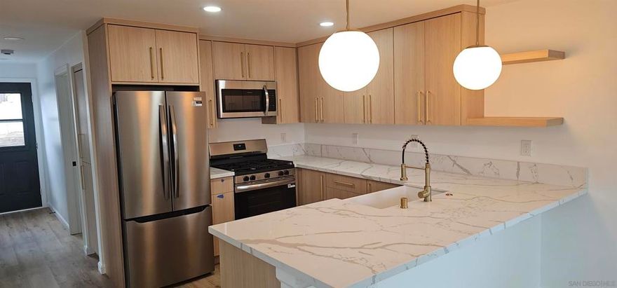 Stunning beautifully renovated 2-bedroom, 1-bathroom home in the heart of La Mesa offering modern charm and a prime location. Just a short walk from the vibrant La Mesa Village, this move-in-ready gem combines contemporary upgrades with an unbeatable location. Step into a bright, open concept living space where the fully updated kitchen steals the show. Featuring custom cabinetry, soft closing cabinets, quartz countertops, stainless steel appliances, gold accents and bar top seating that is perfect for casual mornings. Luxury vinyl plank flooring, fresh paint, creates a warm and inviting vibe. The modern bathroom showcases stylish tiles and premium fixtures. Outside, the oversized backyard is a rare find, complete with a double-gate alley entrance—ideal for an ADU, parking a pull-behind trailer, or a private workshop. Fully fenced for privacy and pets, this expansive lot is perfect for outdoor gatherings, gardening, or simply relaxing in your own oasis. Additional upgrades include energy-efficient windows, LED lighting, and a tankless water heater for ultimate comfort and savings. Located within walking distance to La Mesa Village’s trendy boutiques, cafes, and restaurants, you’ll love the small-town charm with easy access to parks, farmers’ markets, and major highways.