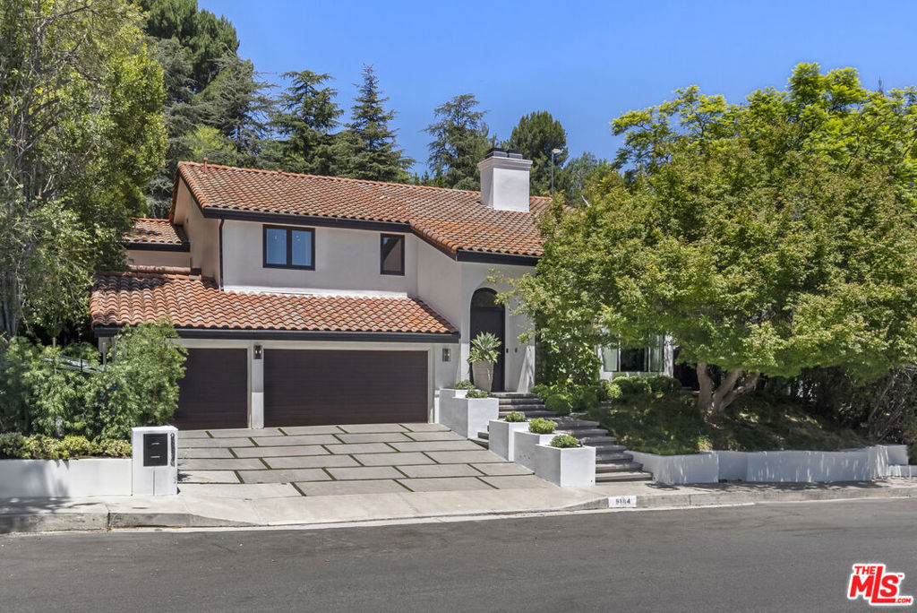 Designer Home on a flat, sidewalk-lined street in Prime Benedict Hills Estates. This updated designer home offers the perfect layout for modern living and entertaining, with soaring ceilings and oversized windows defining the elegant living and dining rooms, while the eat-in chef's kitchen features Calcutta marble, steel shelving, and high-end appliances, flowing into a spacious family that transforms into a full media room with bar. A wall of glass opens to an entertainers backyard with saltwater pool/spa, fire pit, built-in BBQ, multiple seating areas and beautiful landscaping. Upstairs, the luxe primary suite boasts a fireplace, sitting area, balcony, steam shower, sauna, and large walk-in closet. Three additional en-suite bedrooms upstairs, with a downstairs maid's room and a fully converted garage/playroom providing flexible living spaces. Great walking neighborhood with sidewalks and full use of the neighborhood's private tennis courts and 24/7 security. Take advantage of the top-rated Warner Avenue School. Completely move-in ready and available right away.