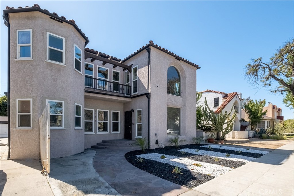 Brand-new construction meets vintage charm in this fully occupied, income-producing Long Beach fourplex bringing in $12,300/month. This fully upgraded four-unit property blends character and modern comfort in a highly accessible Long Beach location. The front unit showcases a vibrant and inviting design with arched doorways, original hardwood flooring, and a bright, open layout. The updated kitchen features bold turquoise shaker cabinets, quartz countertops, a mosaic tile backsplash, stainless steel appliances, and ample natural light. The bathroom offers spa-like finishes with marble-style tile, a soaking tub, a large walk-in shower with built-in niches, and a dual vanity with chrome fixtures. Bedrooms are spacious and airy, maintaining vintage charm while offering everyday functionality. The two rear units have been newly constructed and thoughtfully designed with vaulted ceilings, recessed lighting, and modern wood-style LVT flooring. Each includes an open-concept kitchen with white shaker cabinetry, quartz countertops, designer tile backsplashes, pendant lighting, and stainless steel appliances. Bathrooms are sleek and stylish with glass-enclosed showers, matte black hardware, and quartz-topped vanities. Additional features include mini split heating and cooling systems, modern ceiling fans, and French door access that enhances natural light and indoor-outdoor flow. Each unit enjoys a private entrance and has been finished with durable, low-maintenance materials ideal for rental income or multi-generational living. Located near shopping, schools, freeways, and public transit, this is a turnkey opportunity with both immediate income potential and long-term value.