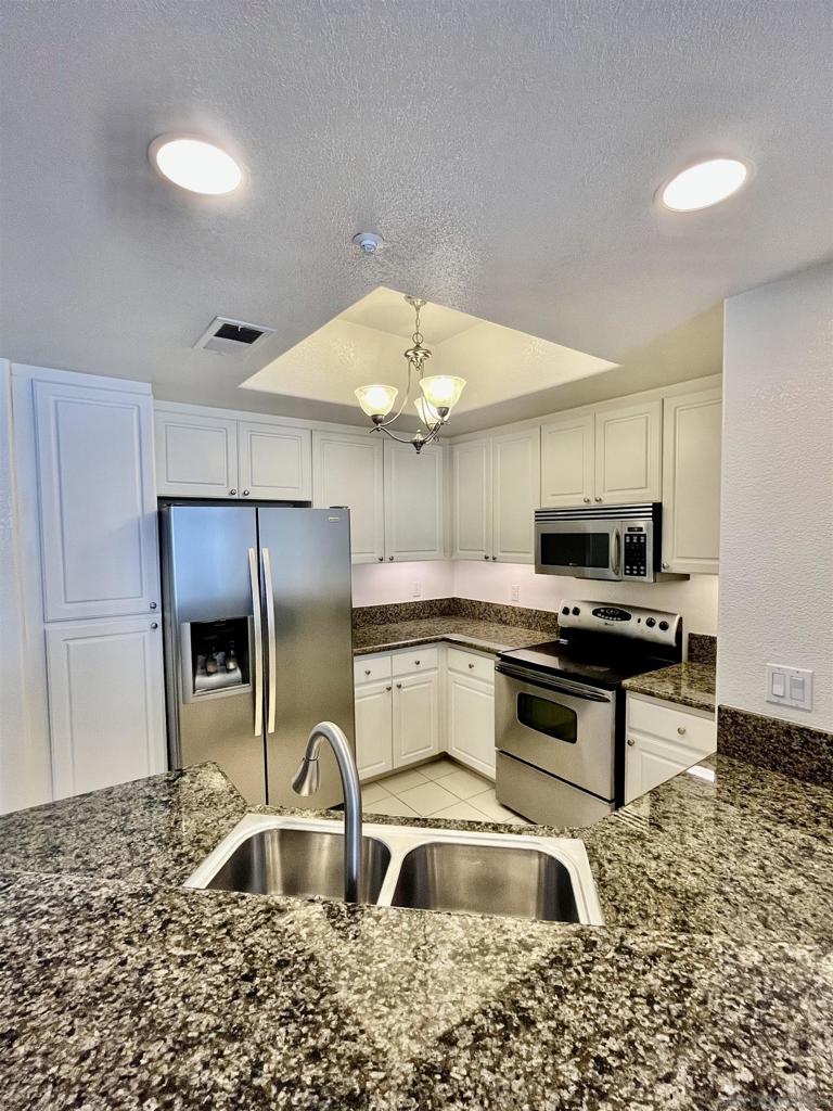Rarely for sale! This naturally bright and spacious condo has engineered wood floors, 9-ft ceilings, crown molding, new paint and newer laundry machines. The roomy balcony overlooks swimming pool. Best location in the complex! Granite countertops and stainless steel appliances; wrap-around breakfast bar. TWO gated assigned underground parking. Near beaches, premier shopping, dining, UCSD, hospitals, and UTC mall. Easy access to MTS bus, Trolley, I-5, 805 and 56.