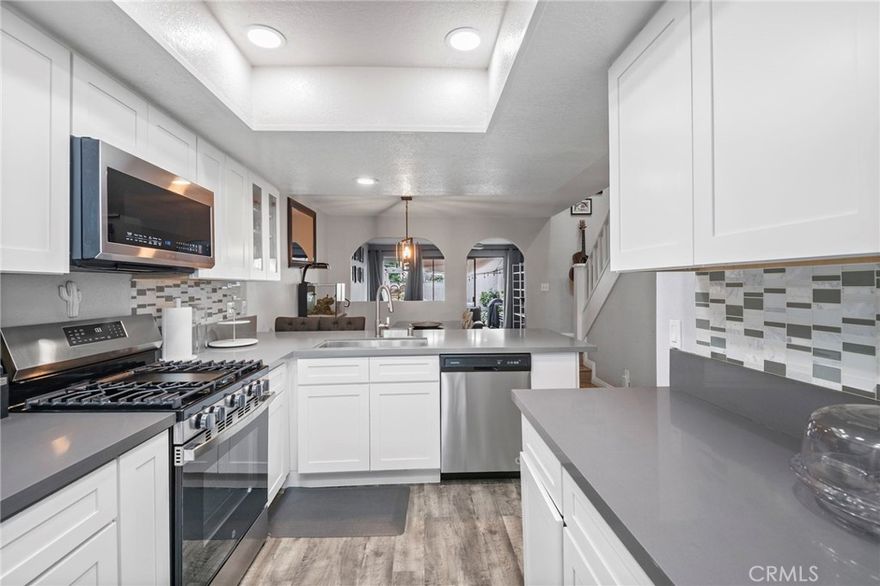 Step into this beautifully remodeled townhome that blends charm, space, and modern comfort. With soaring ceilings and an open-concept layout, this home feels expansive and bright from the moment you enter.
The chef’s kitchen is a true showpiece — featuring neutral quartz countertops, abundant cabinetry, a dedicated pantry, and plenty of prep space for all your culinary adventures. Just off the kitchen, the convenient indoor laundry area makes daily living efficient.
Upstairs, you’ll find two oversized bedrooms filled with natural light. The primary suite is a peaceful retreat, complete with a private balcony overlooking the lush backyard, dual closets, a vanity, and a spa-inspired bathroom with a newly updated shower.
Relax in the inviting living room, where a gas fireplace and large glass doors open to your newly pavered patio — perfect for entertaining or enjoying quiet evenings outdoors. The expansive backyard offers the feel of a single-family home, but without the upkeep! Don't forget about your 2 car detached garage and ample guest parking.
Enjoy community amenities including a sparkling pool, hot tub, and manicured green spaces, all tucked within the serene and well-maintained Chapman Villas neighborhood.
Located near top-rated Troy High School, Cal State Fullerton, local eateries, and downtown Fullerton, this home also offers easy freeway access for commuting convenience.
Homes like this don’t come along often — don’t miss your chance to own this hidden gem!