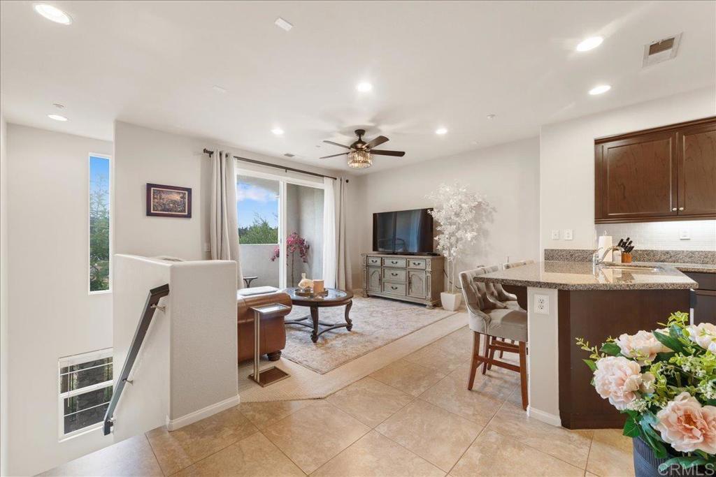 Nestled in the desirable Magnolia community of Old Creek Ranch, this meticulously maintained townhome offers a blend of modern comfort and serene living. Built in 2014, this residence is situated in a rare perimeter location, providing enhanced privacy and stunning west-facing views that capture breathtaking sunsets. Inside, the open-concept floor plan showcases a modern kitchen upgraded with granite countertops, stainless steel appliances, and a breakfast bar that flows effortlessly into the spacious living area. Elegant touches like upgraded backsplash, custom window coverings, and new hardware throughout create a polished, designer feel. The sellers have added numerous thoughtful improvements, including a whole-house water filtration system, Nest thermostat, ceiling fans, and fresh paint, making this home truly move-in ready. Upstairs, both bedrooms feature their own ensuite bathrooms, enhanced with upgraded fixtures and finishes for maximum comfort and convenience. The in-unit laundry is ideally located on the same level. Additional highlights include durable tile flooring, recessed lighting, central air conditioning, and an attached two-car garage with ample storage space, upgraded with epoxy flooring and overhead racks for organization. Residents of Magnolia at Old Creek Ranch enjoy resort-style amenities, including a pool, spa, BBQ area, fire pit, playground, and scenic walking trails. The HOA covers water and exterior maintenance, ensuring a low-maintenance lifestyle. Located just minutes from San Elijo Hills Town Center, award-winning schools, parks, local trails, shopping, dining, and entertainment options, this home perfectly combines comfort, convenience, and location.