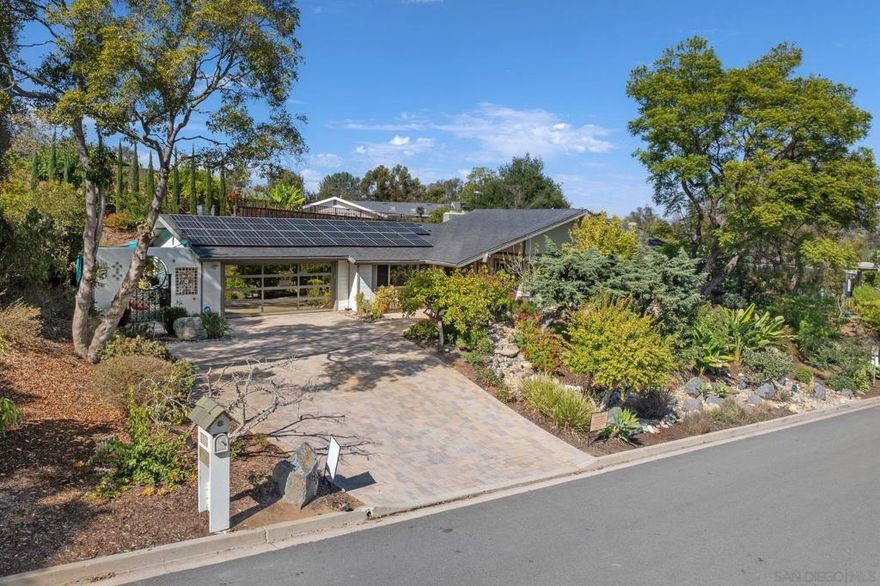 Located in the highly sought-after Horizon Hills neighborhood, this custom-built Mid-Century Modern gem is being offered for the very first time. Designed by the acclaimed architectural duo Sangster & Hamman, the home seamlessly blends timeless design with thoughtful modern updates. Spanning over 2,000 sq. ft., this architectural treasure features vaulted ceilings, an airy open-concept layout, and a dramatic Arizona Driftwood stone fireplace that anchors the main living space. Walls of glass bathe the interiors in natural light, showcasing the home’s clean lines and iconic mid-century aesthetic. The bright, updated kitchen with premium appliances flows effortlessly into the formal dining room—perfect for entertaining or enjoying everyday moments. A built-in beverage refrigerator adds a touch of luxury and convenience. Step outside to your private backyard retreat, where a custom-designed pool is surrounded by lush gardens, mature landscaping, and 13 varieties of fruit trees—including lemon, lime, apricot, persimmon, avocado, fig, guava, mango and pomegranate. Multiple seating areas invite relaxation and conversation, while a screened pergola makes outdoor dining a delight. Custom hardscaping throughout to include a gorgeous driveway and backyard deck....Lovely Telavera Mural outside adds to the uniqueness of the home. Evenings are beautifully illuminated by dawn-to-dusk lighting, lanterns, and a charming three-tiered fountain—creating a peaceful ambiance just outside the bedroom patio. Fantastic BBQ area adds the final touch!  Lovingly maintained and thoughtfully upgraded, this home includes a paid Enphase solar system, new windows and patio doors, Progressive security screens throughout, and a HALO 5 full-house water filtration system. Additional enhancements such as LED lighting, ceiling fans, a new HVAC system and water heater, designer paint, updated glass garage door, and custom wrought-iron gates ensure both comfort and peace of mind. Stylish Zebra shades in the living and dining rooms add the perfect finishing touch. The front yard is equally captivating, with an amazing dry creek bed, decorative fish sculptures, and a mature foilage—all set on over one-third of an acre. Near all: SR94, I8, Avocado Blvd, grocery stores and a quick trip downtown or to the beach.