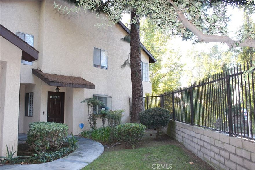 Spacious and move-in ready, this beautifully updated single-level end unit offers 2 bedrooms, 2 bathrooms, an indoor laundry room, and an attached 2-car garage. Enjoy a large primary suite with two generous closets, upgraded bathrooms and kitchen, and wood flooring throughout. The living room features a cozy gas fireplace, and plantation shutters add a touch of elegance throughout the home.  Additional highlights include a covered patio, newer HVAC (approx. 3 years old), and abundant natural light thanks to its end-unit location. Community amenities include multiple pools, guest parking, and serene park-like grounds. A rare blend of privacy, style, and convenience!  The HOA covers water, trash, sewer, roof, termite, gardening, pool maintenance, insurance, and more—making this home both low-maintenance and high-value. Located just minutes from Freeways 60 and 10, shopping, restaurants, and public transportation.