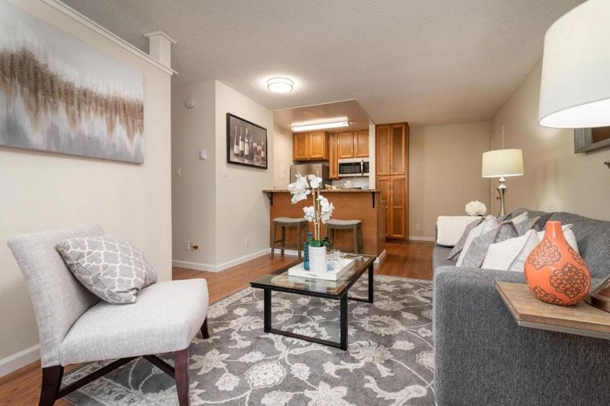 Welcome Home!  Just reduced $10K.  Beautifullly remodeled studio @450 sq ft. converted to a one bedroom.  This Peninsula Place condo has everything you're looking for: updated kitchen and bathroom, new stainless appliances, new wood-look flooring, new vanity, refinished tub, light fixtures, and a convenient sleeping alcove.  Enjoy the afternoon  sun on your oversized patio facing the tranquil courtyard.  Sought after location with sunny western exposure and view of greenery.   Just one bldg from laundry, covered parking and main pool with spa and gym.  Amenities include 4 pools, spa, gym open 24 hours, tennis courts, clubhouse and 24 hour private security.  Pet friendly complex, low HOA fees.