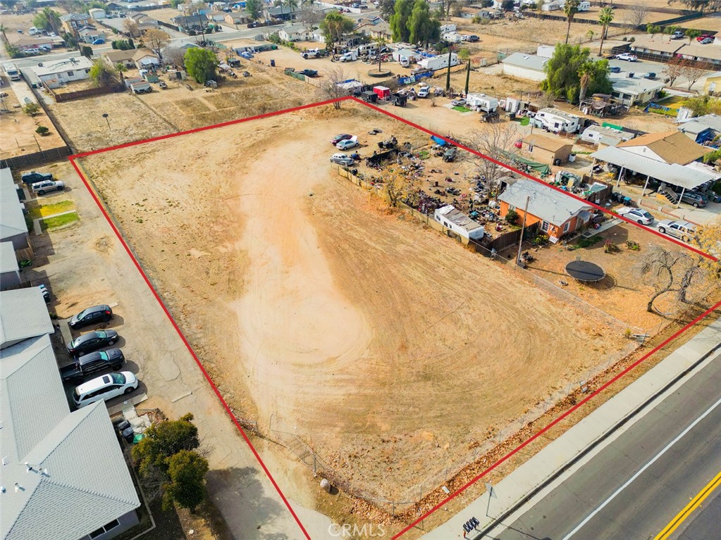 This property has zoning and expired (2022) plans for twenty (20) residences. Seller has a lot of due diligence material to share with buyer. Or Buyer can potentially use the new State Bill (SB) 684 to do a new tract map within a shorter timeframe than usual. Site is directly across from the 16 acre Sunnymead Park which is very nice and popular for local youth sports. Very close to the freeway and shopping such as Sprouts, Target, Costco, etc. The property is mostly raw land, but there is one small house with a tenant. Buyer could keep the house and build 19 new units, or demolish the house to build a brand new (20th) unit. Buyer to verify all with city.