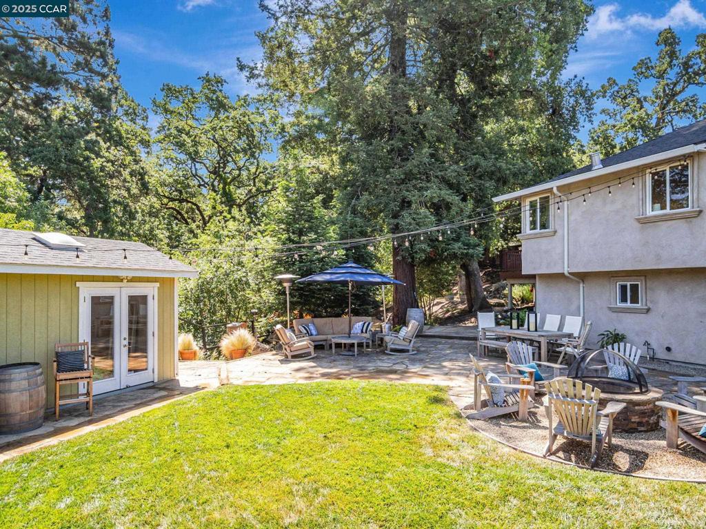 Welcome Home! This exquisite residence, nestled in a serene, wooded setting has 3 bed rooms, office, 3 updated baths, and spans approx.1927 SF plus 300 SF (2 dwellings) on a 15,640 sq ft lot. As you step inside, you are greeted by the warmth of hardwood floors and the refined touch of crown moldings. The light filled living area effortlessly flows into a gourmet kitchen, adorned with granite countertops, gas stove, dishwasher, and ample lighting. Enjoy meals in the adjacent dining area or take them outside to the deck, where a barbecue area awaits for al fresco dining. The home features a home office, an Art studio, and 1 Bathroom Studio (possible ADU conversion). The primary ensuite is a sanctuary, complete with a separate shower and natural light. Additional amenities include Solar, central AC, heating and Attic storage. Outside, the property is a true haven. The backyard boasts a flat lawn, courtyard, and a delightful garden. Engage in leisurely activities in the playground, sand box, possible dog run and a chicken/bunny coop. Unwind by the fire pit or soak in the hot tub as you listen to the tranquil sounds of the seasonal creek. Entrance to Garage and House off Moraga Ct. Street parking on Moraga Ct. Top rated Orinda schools. Close to BART, Freeway and Downtown Orinda!