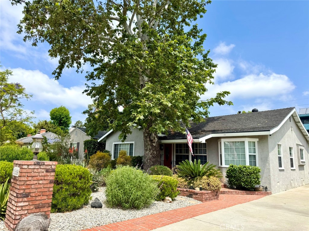 Welcome to 11559 Blix St., a charming and light-filled home in an unbeatable location in a multi-million dollar neighborhood! From the inviting front porch to the sun-drenched living room with large windows, this home exudes warmth and character. Inside, beautiful hardwood floors flow through the living room, the formal dining room with wainscoting and the cozy wood-paneled den with a fireplace. The galley-style kitchen features a delightful breakfast nook and an adjacent laundry room for added convenience. A spacious primary suite at the rear of the home offers a peaceful retreat with an ensuite bath. The oversized two-car garage includes a versatile bonus room, perfect for a craft space, home office, or gym. With ADU and expansion potential, this property offers endless possibilities. A concrete driveway provides ample parking, and the fantastic location puts you close to shopping, dining, and entertainment. This home is waiting for your personal touches to modernize it and make it your dream home!