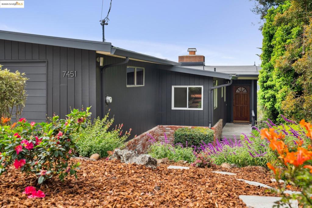 Built in 1962, this Mid-century gem in the El Cerrito hills offers great views and plenty of space! Just past the formal entry hall, the large living room and dining room, with vaulted, exposed beam ceiling, offer a wall of windows and a slider to the deck, highlighting expansive views of San Francisco, the Bay, bridges, and Mt. Tam. A fireplace that opens to both the living room and the family room on the other side creates a cozy ambiance in this open space. The kitchen, adjacent large breakfast room, and family room combine to offer a second open area for together time. The main level also features the primary bedroom, a full bath, and a second bedroom. Stairs down to the lower level lead to a second family room area, three additional bedrooms, a second full bath, a laundry room, and a workshop with a separate hobby room/office. The back door opens to a lower deck and stairs to the terraced backyard with a patio area. 2,476 sq ft* on a 6,210 sq ft* lot. Close to local schools, public transportation, El Cerrito Plaza, and BART. *Per public record. Views: Downtown