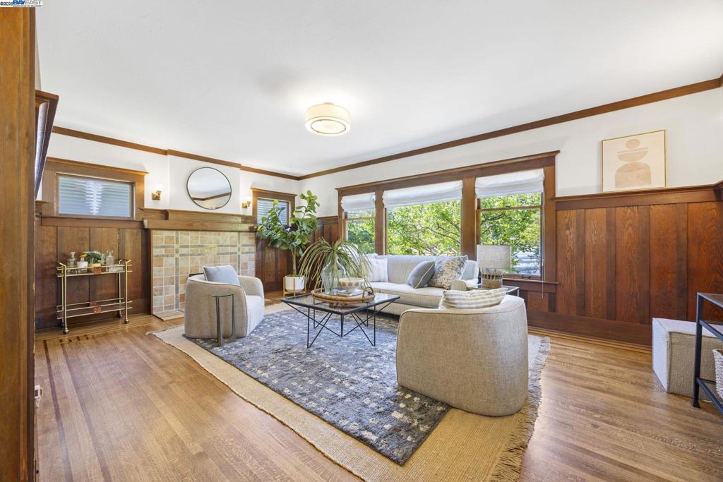 Located in one of the most picturesque neighborhoods in all of Alameda, this spacious 1910 shingled Craftsman has charm to spare both inside and out! Situated on an unusually large corner lot, the home features 4BR, 2BA, a formal foyer, impressive living & dining rooms, a kitchen w/adjoining laundry room, a detached garage & a large front sitting porch surrounded by a lovely garden & mature fruit trees. Inside, period architectural details include Douglas fir wainscot panels, untouched window & door trim, picture rails, crown moulding + oak floors w/rosewood borders. The DR has bay windows, a fireplace & a spectacular Odeon crystal chandelier/ The spacious LR has a fireplace w/a gorgeous Craftsman tile surround & much more. The primary BR suite includes a sunny ensuite nursery/home office/flex room, a cedar-lined closet + a Harlow crystal light fixture. The 2 sun-filled upstairs bedrooms have vintage tongue & groove paneling, skylights and built-in book shelves. Wonderful front & back yards include pavers + 7 varieties of fruit trees. Detached garage presents possibilities. Off-street tandem parking for multiple cars. This is a truly exceptional vintage home in a sought-after Alameda location w/classic Craftsman features, and lush, very private outdoor spaces. Perfection!