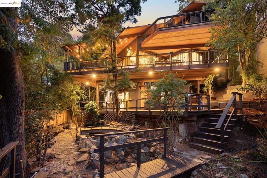 Piedmont Pines Mid Century Retreat. Nestled among the trees, this serene mid-century home offers the feeling of a Tahoe getaway just minutes from Montclair Village. The main house features 4+ bedrooms, 2 bathrooms, two spacious living rooms, and flexible spaces ideal for a media room, office, or gym. An additional 1-bedroom, 1-bath suite with a private entrance is perfect for guests or an au pair. Designed for effortless indoor/outdoor living, the home opens to expansive private decks leading to a tranquil pond and level play area, hot tub and surrounded by gardens with a Japanese-inspired design. Enjoy glimpses of the Bay, a fully remodeled kitchen, and an open floor plan with warm wood finishes, a wet bar, and sliding glass doors framing lush greenery. Conveniently located near Hwy 13 and scenic hiking and biking trails, this one-of-a-kind property offers privacy, beauty, and a true connection to nature—just moments from city life. Close to top rated schools, East Bay Parks and much more!