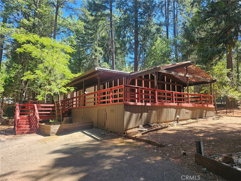 Spacious 3 Bedroom Home on 1.27 Acres Surrounded by Towering Pines! Nestled in a peaceful wooded setting, this stunning 3 bedroom, 2 bath home offers the perfect blend of comfort, privacy, and functionality on 1.27 acres. Surrounded by beautiful pine trees, this property features a circle driveway, RV parking, and a detached garage with a workshop area and additional bedroom—perfect for guests, hobbies, or a private office space.
Step inside to a bright and airy interior with floor-to-ceiling windows that fill the home with natural sunlight. Enjoy new flooring throughout, a large kitchen with breakfast nook, and a formal dining room for entertaining. The spacious master suite boasts a sunken tub, large vanity and ample cabinet storage. Relax or entertain on the expansive wrap-around deck, ideal for soaking in the serene surroundings. The home also features an intercom system throughout and a brand-new roof, giving you peace of mind for years to come. Don’t miss this unique opportunity to own a peaceful retreat with space, privacy, and modern updates. Schedule your showing today!