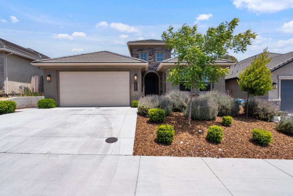 This is it! Desirable Santana Ranch home, popular Pismo floor plan provides a seamless great room, kitchen living space and 3BD/2.5Bths. This home showcases a great open concept floor plan and very nice upgrades that include granite countertops, full subway backsplash, generous island with sink, stainless steel Bosch appliances, spacious pantry, warm hue wide plank tile from entry throughout the great room, kitchen and dining area....very recent new carpet installed throughout bedrooms, gas log fireplace with blower, ceiling fans in the spacious owners suite and Great room, the owners suite also offers a spacious walk-in closet adjacent to a private bathroom with dual vanity sinks and soaking tub with separate shower and slider access to backyard...A/C...nice patio with Hot tub waiting for you in backyard. Garage is plumbed for EV charger. A must see !