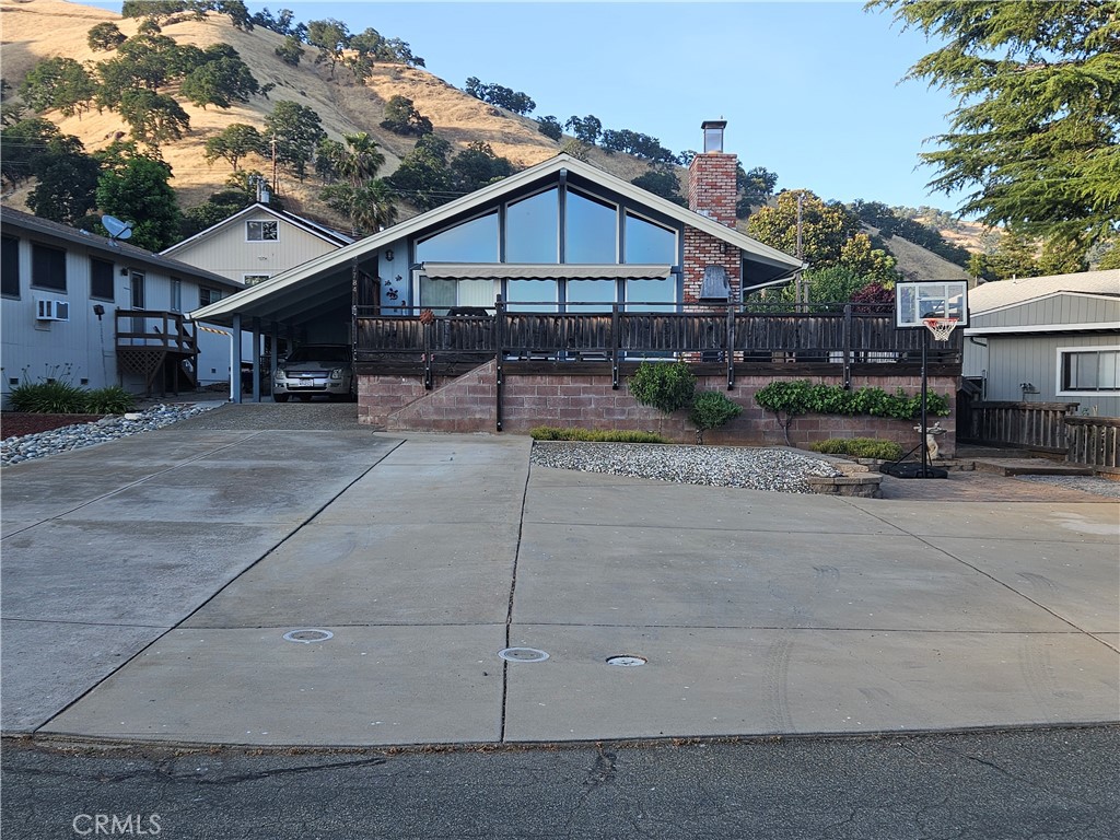 Welcome to Kono Tayee! Inside this small, friendly HOA community you will find a beautiful home located at 7784 Richard Drive, technically in the town of Lucerne, CA. This updated and impeccably maintained home boasts newer laminate flooring, bathroom, appliances, skylights, fencing, and energy efficient features such as a generator hookup for power outages. In addition, a wood burning fireplace, large West facing windows overlooking the outdoor patio which is equipped with a built in BBQ & motorized awning which directly views the beautiful Mt. Konocti. Special features include closets with built in drawers, Walk-In Shower with Dual Showerheads, 20 panel "owned and paid off" Solar System, Bluetooth enabled electric water heater on timer, oversized and attached carport plus uncovered parking for an RV or additional vehicles, fully powered workshop with 1/2 bath & Utility sink, and a blank canvas for landscaping in the backyard. For our warmer days, the home in equipped with an adjustable & quiet 3.5 ton HVAC unit located in the rear next to the detached storage shed. HOA amenities include a Members Only beach, boat launch, pier, BBQ area, boat docks, and swim dock THIS HOME WILL NOT LAST! If you're ready for the relaxed Lake Life, or the perfect Summer home, this is the one for you!