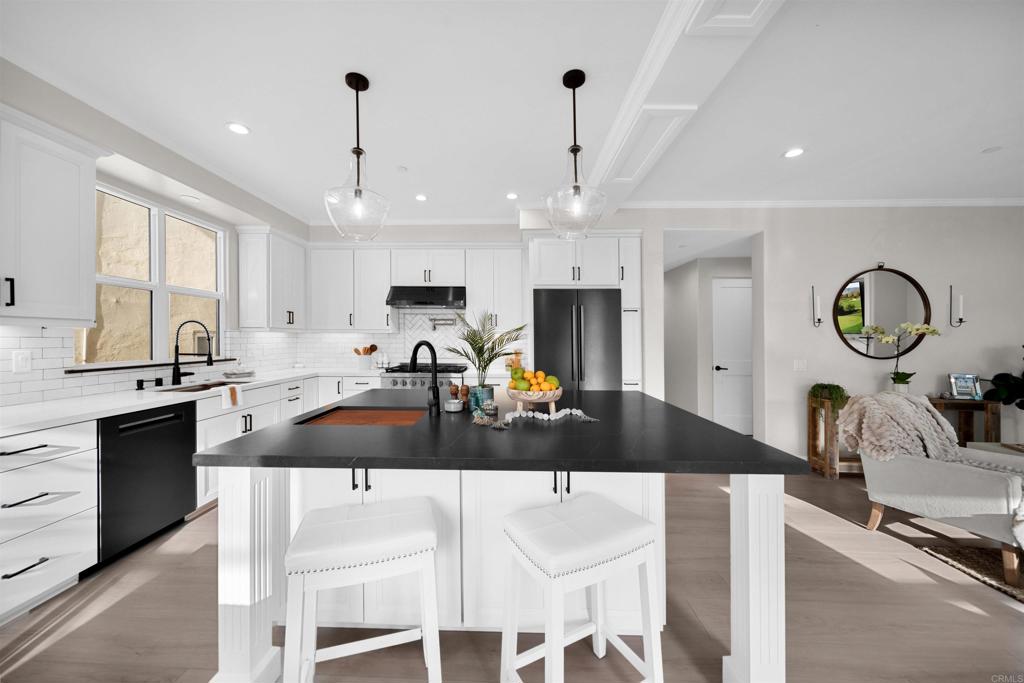 Discover your dream home with this exquisite new construction located near the vibrant heart of the coastal Oceanside community! Just a short walk away, you'll find beautiful beaches, eclectic restaurants, charming boutiques, lively breweries, and an exciting nightlife scene, as well as convenient bike paths and a welcoming community atmosphere. Designed with luxury in mind, this home features top-of-the-line appliances and upscale designer materials. Revel in the elegance of marble countertops alongside the stunning leather-finished granite kitchen island—an entertainer's delight! The main floor includes a full ensuite bath and a bedroom that opens up to its own private balcony. On the lower level, you’ll find two more spacious bedrooms with full bathrooms, including the luxurious primary suite. It boasts a stackable washer/dryer, a soaking tub, and generous walk-in closets for all your storage needs. Flexibility abounds with the option to separate and lock off the main floor from the lower level, offering privacy for guests or an excellent rental opportunity. The downstairs also impresses with a large bonus living area, featuring a kitchenette/bar that seamlessly connects to the outdoor courtyard through expansive folding glass doors. Enjoy the ultimate in year-round entertainment while grilling and gathering around a cozy firepit setting. Located at 812 N Cleveland Street, this property stands out along the entire San Diego coast for its unparalleled design and prime location. Don’t miss the chance to make this one-of-a-kind coastal retreat your own!