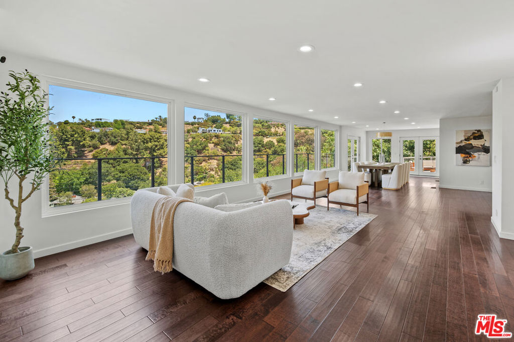 Nestled in the desirable neighborhood of Encino Hills, this stunning 5-bedroom, 3.5-bathroom home spans 4,348 square feet and offers unmatched privacy with sweeping canyon and valley views. Bathed in natural light and showcasing vistas from nearly every room, this architectural gem is the perfect blend of sophistication and California comfort. A dramatic two-story entry welcomes you to a home that is both grand and inviting. The sun-drenched living room is framed by a wall of windows that highlights the home's panoramic canyon views. An adjacent family room features soaring two-story ceilings, custom built-ins, a cozy fireplace and easy access to one of the many outdoor spaces. The gourmet chef's kitchen boasts an oversized center island, quartz countertops, stainless steel Viking appliances and an abundance of storage ideal for both everyday living and entertaining in style. The nearby dining space opens to a scenic patio, perfect for al fresco dining. An impressive office with custom built-ins is highlighted by an additional terrace perched above the treetops, creating the ultimate work-from-home sanctuary. The luxurious primary suite is a serene escape with vaulted ceilings, a spacious walk-in closet and a private patio with jaw-dropping views. The spa-like primary bath features dual sinks, spa tub and separate shower. Four additional well proportioned bedrooms offer an array of vaulted ceilings, skylights and direct access to a private yard with multiple seating areas and a cozy fire pit.With easy access to the Westside and perfectly positioned near the award-winning Lanai Road Elementary School, this elegant property is just minutes from Encino's top restaurants, shopping, parks and hiking trails. This home represents an extraordinary opportunity to live in one of L.A.'s most sought-after neighborhoods!
