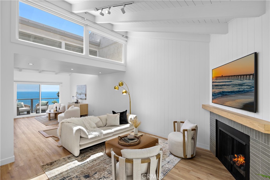 A luxurious coastal retreat perfectly capturing the elegance and stye of upscale beach living. Completely remodeled and offering stunning panoramic views of the ocean, Catalina Island, white water, rocks, and sand from every room—a full sensory experience with gorgeous sunsets and twinkling city lights.
This spacious 2 bedroom, 3 bathroom condo has been thoughtfully reimagined with a blend of high-end finishes and comfortable design. The upper level welcomes you into a spacious light-filled living room with cathedral beamed ceilings, painted tongue and groove walls, a cozy gas fireplace finished with ceramic tile and a wood mantel, and warm wood-like vinyl floors. The open floor plan draws you past the living room to the captivating views, leading you to a cozy den that opens to a deck—ideal for relaxing, socializing, and enjoying the ocean breezes.
The kitchen is a dream, featuring all-new stainless steel appliances, a six-burner stove, custom cabinetry and a breakfast bar that invites conversation. The deep green tile backsplash and open wood shelves add a touch of natural elegance, while the wine fridge and walk-in pantry ensure you're ready for any gathering. Adjacent to the kitchen, the dining room offers front-row views, creating the perfect setting to gather with family and friends.
Glass handrails elegantly frame the stairs and decks, enhancing the open and light filled rooms. The lower level includes a primary suite with a private deck, a desk area with built-ins, a walk-in closet, a separate tub, walk-in shower, and dual sinks. The second bedroom offers a deck with views and a large closet. This level also includes a laundry room with new washer and dryer, a second bathroom with a walk-in shower, and a large storage closet.
This highly-desired community features an elevator to all levels, including the parking garage, where you'll find a dedicated space and storage. Proximity to the elevator is also a big bonus for this condo. Enjoy the heated community pool, sun deck, outdoor shower, and bath facilities. Located just steps from the Montage Resort, beautiful beaches, popular Laguna restaurants, a shopping center, 2 large parks, Laguna Trolley stops and more!.
Don't miss out on the opportunity to own a piece of luxurious Souther California living; properties in this sought-after community have sold quickly. Live the sophisticated beach life with a blend of style and serenity in this stunning coastal home.