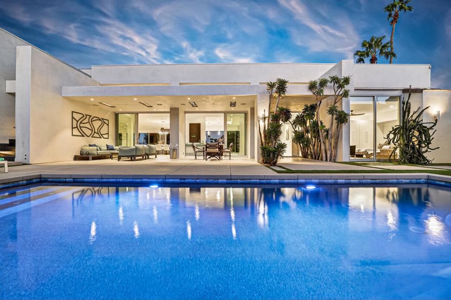 Experience modern desert luxury at its finest in this exceptional 4-bedroom, 5.75-bathroom estate, perfectly positioned adjacent to the tee on the 14th fairway of Ironwood Country Club's prestigious North Course. Originally built in 1984 and completely reimagined in 2018, this residence combines timeless architecture with contemporary design is offered TURNKEY FURNISHED, showcasing impeccable craftsmanship, high-end finishes, and the functionality of a newly built home. Step through the gated front courtyard into an expansive great room featuring soaring ceilings, recessed lighting, a dramatic fireplace, and 24-inch slate tile flooring that flows seamlessly throughout. Floor-to-ceiling pocket sliding doors blur the lines between indoor and outdoor living, while upgraded windows and custom window treatments frame breathtaking golf course views from nearly every room. The gourmet kitchen is a chef's masterpiece, boasting quartz countertops, custom cabinetry, premium stainless steel appliances, a wine chiller, and a temperature-controlled wine closet. Brand NEW whole house water filtration system! The luxurious primary suite serves as a private sanctuary, offering dual bathrooms, a dedicated office space, and direct patio access. Two additional ensuite guest bedrooms open onto private outdoor sitting areas, while a detached casita--complete with a living area, wet bar, bedroom, and full bath--provides the perfect retreat for guests. Designed for entertaining, the home's 29' x 30' second-story observation deck captures sweeping panoramic views of the fairway and surrounding mountains. The resort-style courtyard is a true desert oasis featuring a sparkling Pebble Tec pool, spa, fire pit, built-in grill, and covered dining area surrounded by lush, low-maintenance desert landscaping. Sustainable luxury comes with a fully owned 42-panel solar system for maximum energy efficiency. Enjoy your own fruit harvest with mature avocado, peach, guava, grapefruit, lemon, and fig trees. Every detail of this extraordinary home has been meticulously curated to deliver elegance, comfort, and sophistication--an unparalleled lifestyle in one of Palm Desert's most desirable communities. Experience the ultimate in golf course living--schedule your private tour today!