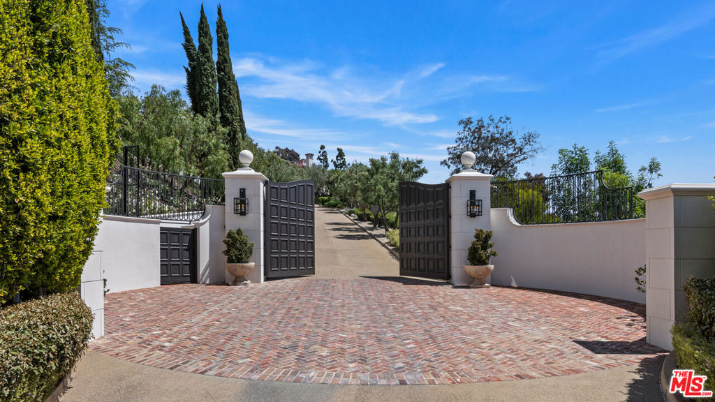Set on nearly 20 acres behind a long private gated drive, overlooking spectacular city views, this stunning Contemporary Mediterranean Villa captures the warmth and beauty of Southern California living. This property defies description with over 25,000+ sq ft, 7 bedrooms, 13 full baths & 9 half baths, 9 fireplaces, an elevator, garage & motor court to accommodate 15 cars, staff quarters offering 3 bedrooms & separate full kitchen. The interiors have been designed for modern lifestyles, yet pay homage to timeless European elegance, which include a formal living room, dining room, library, commercial-grade gourmet kitchen, breakfast nook, family room, gym, game room, projection screening room, wine cellar & dining room. Offering a perfect setting for an outdoor soiree, the grounds inspire the kind of serenity found in the world's most secluded villas w/ immaculate lawns & gardens, orchards, fountains, a mosaic-tiled swimming pool, outdoor pavilion, pool house w/ kitchen & pizza oven, tennis court & pavilion, walking paths & a view to envy.