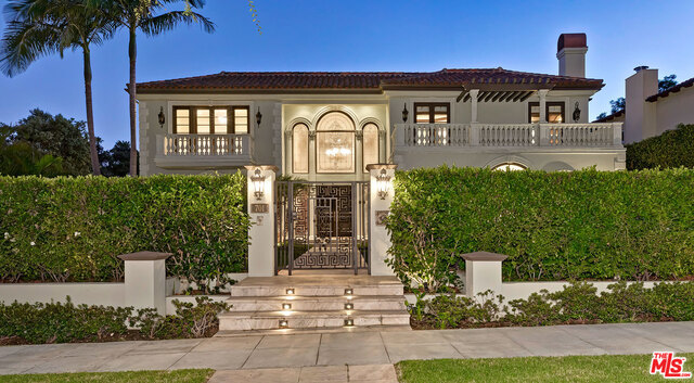 A most elegant gated Mediterranean estate sited at a commanding corner on one of the the Flats' most coveted 700 blocks. Voluminous spaces tastefully renovated in 2005 exhibit complete glamour complimented by fine materials. Featuring stone floors, French doors, mouldings, wainscotting, and built-ins. A dramatic 2sty foyer with sweeping staircase sets the tone. Grand formal living and dining rooms. Stunning office/library. Separate large gym and mammoth family room. Chef's kitchen and walk-in pantry beyond compare. Phenomenal master suite with sitting area, fireplace, two balconies, dual luxurious baths, and walk-ins. Each bedroom is 'en suite'. 2 powder rooms. Lower level with great room, fantastic bar, fireplace, lounge, professional theatre, wine storage. Kitchen and family room open to lush private grounds with a covered patio, fireplace, BBQ center, lawns, trampoline, pool, waterfall spa, and mature hedging. Truly a jewel in the Flats of Beverly Hills and within moments from all.