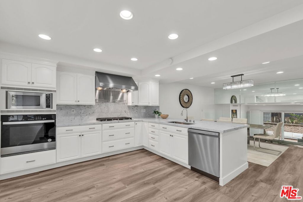 Located on a quiet cul-de-sac in the heart of Silicon Beach, this beautifully renovated 3BD/2.5BA townhome offers the largest floor plan in La Villa Marina, approximately 2,002 SF of refined living space. The open layout features designer finishes throughout, including new flooring, recessed lighting, new Carrera marble countertops, and fully remodeled bathrooms. Both full bathrooms are brand new and have never been used offering a truly fresh start for the new owner. The spacious living room with fireplace flows seamlessly to an oversized private patio, ideal for indoor-outdoor living. Upstairs, all three bedrooms are generously sized, including a luxurious primary suite with a spa-like ensuite bath and dual vanity. The kitchen is equipped with mostly brand new, never-been-used appliances, combining modern style with everyday functionality perfect for the home chef or entertaining guests. Additional highlights include in-unit side-by-side laundry, central air/heat and a private direct-access garage that fits up to three cars with bonus storage. Villa St. Tropez amenities include a pool and community patio. Unbeatable location near Trader Joe's, Pavilions, Marina Marketplace, top restaurants, and more. A rare opportunity to own a move-in ready, designer-upgraded home in one of the Westside's most coveted neighborhoods.