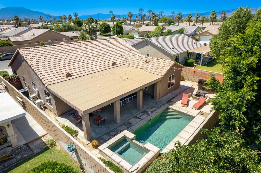 No HOA, No Mello Roos, and no short-term rental restrictions--this is the investment you've been waiting for! Whether you're looking for a proven income property or your own desert retreat, this 4-bedroom, 2-bath saltwater pool home checks every box.Step inside to an open floor plan with vaulted ceilings, stacked stone accents, tile floors in the main living areas, and a versatile office/den. The kitchen features granite countertops, a spacious island with bar seating, and opens seamlessly to the dining and living room--perfect for entertaining.The primary suite offers a walk-in closet, dual vanities, soaking tub, separate shower, ceiling fan, and abundant natural light. Three additional guest bedrooms are located opposite the primary for added privacy, each with ceiling fans and cozy carpeting. An extra flex space provides endless options for a home office, media room, or reading nook.The backyard is designed for relaxation and entertaining, with an oversized covered patio, built-in BBQ, wood-burning fire pit, tanning deck, and low-maintenance landscaping. Conveniently located near shopping, dining, and the Festival grounds, this home truly has it all. Rental history available upon request--don't miss this must-see opportunity!