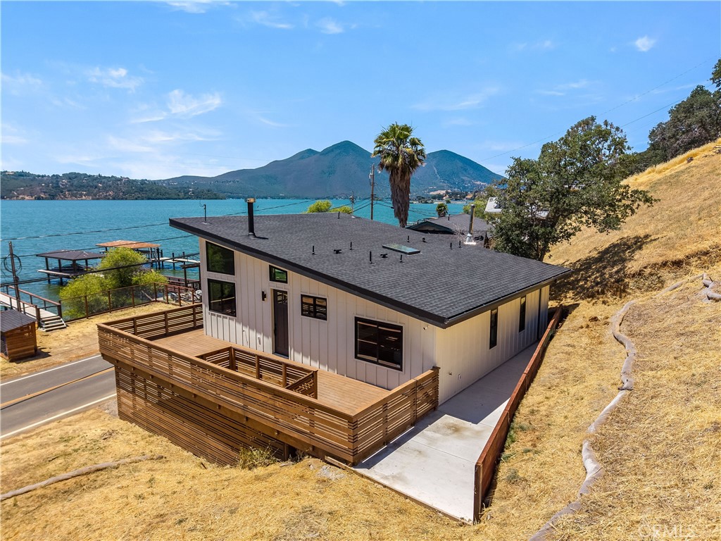 Lakefront Dream Home with Dock - Welcome to this beautifully remodeled lakefront property, where no detail has been overlooked. Completely renovated from the foundation up, the home features all-new electrical, HVAC with updated ducting, and modern plumbing. A newly constructed steel-reinforced retaining wall adds to the property's structural integrity, while a spacious wraparound deck and convenient carport enhance its functionality and outdoor appeal.
Inside, oversized Andersen windows frame breathtaking lake views and flood the open-concept living space with natural light. The interior boasts soaring ceilings, a thoughtfully designed layout, and elegant finishes throughout. Recessed lighting is installed across the home, equipped with Lutron dimmers, and the entire property is pre-wired for sound and secured with a Lorex surveillance system.
The kitchen is a true showstopper, featuring brand-new stainless steel KitchenAid appliances, a wine fridge, designer water fixtures, and an under-slab sink. Sleek Italian porcelain waterfall countertops complete the modern, high-end aesthetic.
Down the hall, you’ll find two generously sized bedrooms and a stunning hallway bath that’s sure to impress even the most discerning guests. The primary suite offers its own luxurious en suite bath with Italian porcelain counters and a beautifully tiled shower.
On the lower level, a fully equipped guest area with a separate entrance awaits. This space includes a kitchenette with butcher block counters, stained concrete floors, one bedroom, and a full bathroom — all designed with the same attention to quality and style as the main level.
The property also features an automatic dock built with durable steel pilings and aluminum slats, ensuring long-term reliability and minimal maintenance.
Move-in ready and impeccably upgraded, this lakefront home is waiting for you — just bring your toothbrush, boat, and fishing rod!