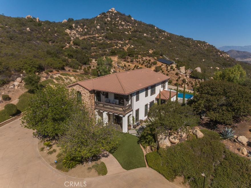 Welcome home to your own private, picturesque retreat! If you’ve been searching for the ultimate indoor–outdoor getaway—complete with a fully handicapped-accessible suite featuring its own entrance, bedroom, bathroom, and living area—this property has it all. Set on 4.96 serene acres, the grounds offer mature trees, stunning boulders, scenic hiking trails, a seasonal stream, and unobstructed views that stretch for miles.
The 3,615 sq ft residence features a formal living room, dining room, and a spacious family room with a fireplace, built-in cabinetry, and an integrated sound system. The kitchen is ideal for both cooking and gathering, showcasing a large eat-at island with cooktop, stainless steel appliances, and beautiful Canac maple cabinetry. An attached oversized three-car garage provides epoxy flooring, built-in storage, and an additional laundry area.
Upstairs, you'll find a generous game room with a private balcony, three secondary bedrooms, and an expansive primary suite—complete with its own balcony overlooking the infinity pool and capturing those breathtaking forever views.
Notable interior features include exposed distressed beams, whole-house fan, newer energy-efficient windows, and solar.
Outdoor living is truly exceptional here. Enjoy a covered dining area, cozy sitting with wood-burning fireplace and built in heaters, outdoor kitchen, hammock retreat, infinity pool with water loungers, spa, sports court, and private hiking trails—all framed by panoramic vistas.
This secluded paradise is truly a must-see!