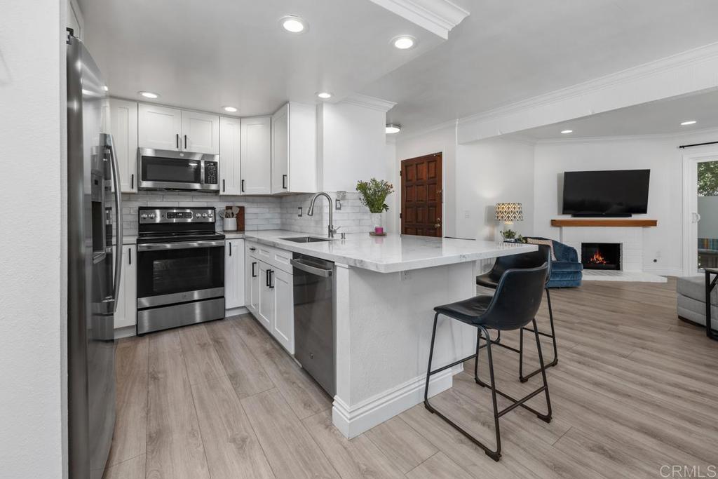 Welcome to The Woodlands – a beautifully upgraded ground-floor 3-bedroom, 2-bath condo located in the desirable San Carlos community of San Diego! This first-floor, 1,141 sq. ft. unit offers modern style, quality upgrades, and exceptional convenience in a quiet, well-maintained complex. Enjoy a renovated kitchen with quartz countertops, soft-close cabinets, and all-new stainless steel appliances—perfect for both everyday living and entertaining. The home features fresh paint, luxury vinyl plank flooring, and upgraded baseboards throughout. Both bathrooms have been fully remodeled with quartz counters, featuring a walk-in shower in the primary suite and a tub in the hallway bath. Additional highlights include: *Central heat and AC *In-unit laundry *Dual-pane windows with vinyl shutters and blackout shades *Crown molding for a polished finish *Spacious closets with custom built-ins *Gas fireplace with a custom white maple mantle *Oversized private patio ideal for relaxing or hosting *Attached 2-car garage with direct access to the unit Residents of The Woodlands enjoy resort-style amenities including a pool, jacuzzi, tennis courts, and dog parks in this pet-friendly community. Located within a top-ranked school district and walking distance to coffee shops, hiking trails, the library, and grocery stores, this home offers the best of both lifestyle and location. Don't miss your chance to own this beautifully upgraded condo in one of San Diego’s most sought-after neighborhoods!