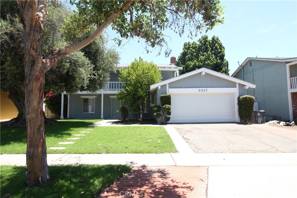 If you need space, this is the one for you! This lovely 5BR/3BA home has massive curb appeal and includes new updates such as bright, fresh paint and new vinyl plank flooring throughout. The lower level features the family room with gas fireplace, formal dining, galley kitchen with updated cabinets, living room, washer/dryer hookups, and one bedroom with attached bath. Upstairs you will find the primary suite with XL walk-in closet, and 3 additional bedrooms with a step-out onto the outdoor balcony. A spacious backyard and 2 car garage complete this home. With the desirable school district of award-winning Tustin United, you'll experience the best of Santa Ana living here!