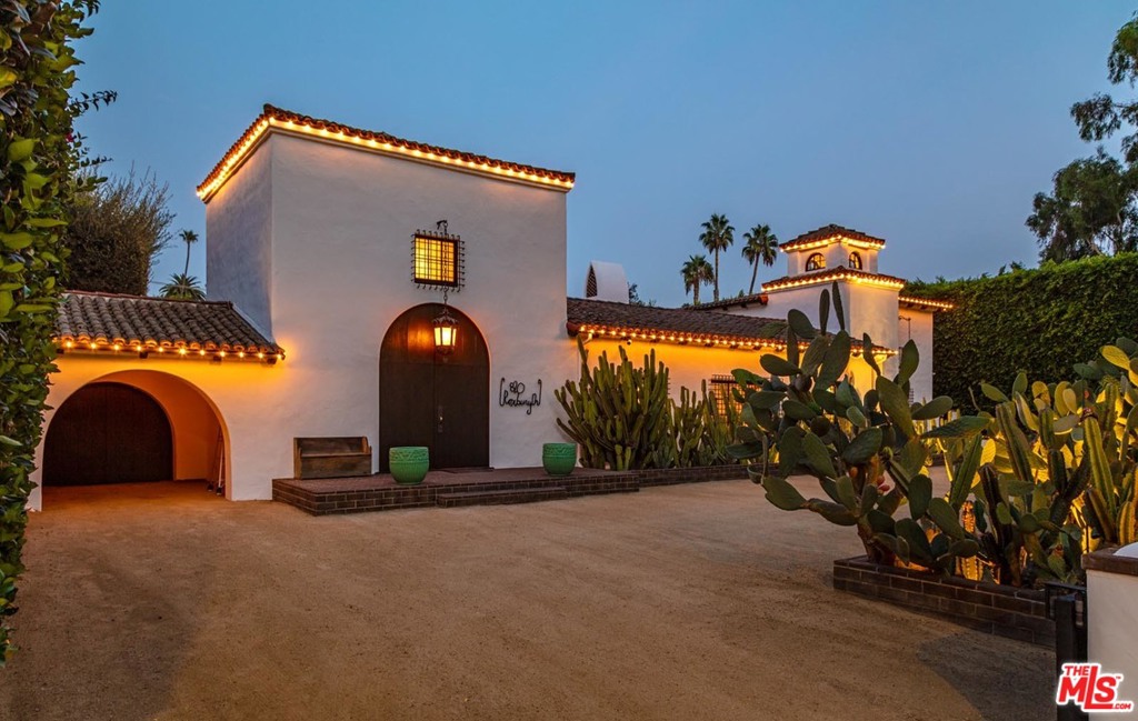 Gracious Spanish Colonial style villa designed by Ralph Flewelling exquisitely updated to balance traditional details with contemporary amenities. Prime BH Flats and celebrity pedigree, ideal for tranquil privacy and brilliant entertaining. Wide arched doorways, chandelier-height truss ceilings, wood and terracotta tile floors, wrought iron detailing. Main living spaces opens to a peaceful central courtyard. Entry hall is fabulous library with groin vault ceiling. Grand formal living and dining rooms, plus den/media room, office, and spectacular kitchen/great room withfamily room/sitting area. Two ground floor bedrooms plus four upstairs including majestic owners suite with fireplace, two full baths, and two balconies overlooking courtyard and backyard. Serenely landscaped backyard offers ample outdoor spacefor dining, seating, pool/spa recreation, plus lovely guest house. Hollywood glamour and up-to-date amenities add up to a legacy property of exceptional luxury, quality, and grace.