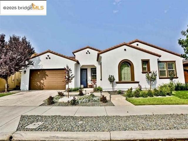 Former model home with tons of upgrades. This lovely one-story single family home is featuring and open and airy floor plan with 4 bedrooms plus and office and 3.5 bathrooms with appx. 2981 sq. ft. on a beautiful lot. Attached 3 car garage and wide side gate access for additional parking or RV parking. Gourmet chef kitchen with top of the line appliances, island, modern backsplash, gas range, granite countertop, and contemporary cabinets. Dinning area with build-in wine refrigerator. Beautifully landscaped backyard with expanded sitting area. enjoy the outdoor kitchen with a built-in firewood oven, BBQ grill, and refrigerator for your outdoor entertainment. Laundry room with built in cabinets and sink along with washer and dryer. this home is loaded with upgrades, plantation shutters, built in speakers, modern bathroom, owned solar with upgraded panels to lower your PGE bill. Tile throughout, modern shed in backyard. California Room with its own hot tub and much more. Hurry it wont last...