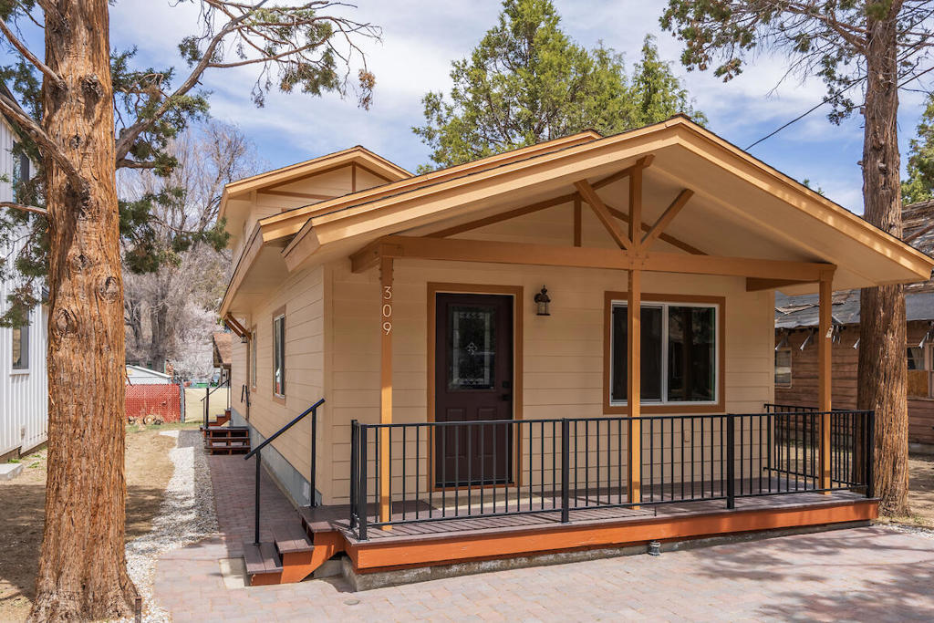 This home has been completely remodeled and finished in May 2025 - Like New Construction. This fully reimagined home is sure to impress. Renovated from the ground up, its effective year is now 2025, offering the quality and feel of new construction. Every detail has been thoughtfully reconstructed, including new framing, insulation, raised perimeter foundation, exterior siding, roof, interior walls, electrical, and plumbing--everything is brand new. Inside, the 1,244 sq ft layout showcases a stylish open-concept living and dining area, accented by luxury vinyl plank flooring, quartz countertops, and stainless steel appliances. The home features two spacious bedroom suites, each designed for comfort and privacy. The main-level suite includes dual access to the primary bathroom from both the hallway and the bedroom, along with a walk-in shower. The second suite, located on the upper level, offers a private retreat. Enjoy outdoor living year-round with a south-facing covered front deck, great for morning coffee, and a rear deck accessible from the lower suite's sliding glass door, offering breathtaking views of Gold Mountain.