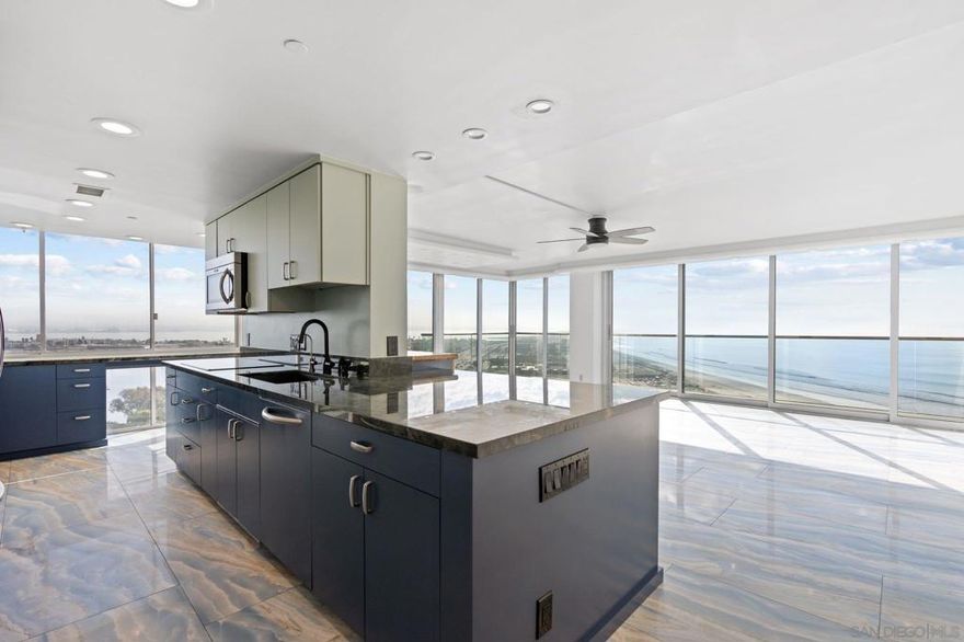 Discover the pinnacle of coastal sophistication from the 15th floor of the prestigious Coronado Shores El Mirador Tower. This exquisite 2-bedroom plus den, 2.5-bath residence showcases sweeping views of the Pacific Ocean and Glorietta Bay — a breathtaking canvas for everyday living.    Meticulously reimagined, the interior features floor-to-ceiling glass walls, rare Labradorite stone countertops, and polished Italian porcelain tile flooring that radiates timeless elegance. The seamless open layout offers both refinement and relaxation, designed for effortless modern living.    Residents enjoy a truly lock-and-leave lifestyle enhanced by 24-hour security, direct beach access, ocean-view pools, tennis and pickleball courts, and a fully equipped fitness center. Ideally located just steps from the legendary Hotel del Coronado, fine dining, and boutique shopping, this turnkey retreat embodies luxury, convenience, and coastal serenity.    Schedule your private tour today and experience elevated oceanfront living at its finest.