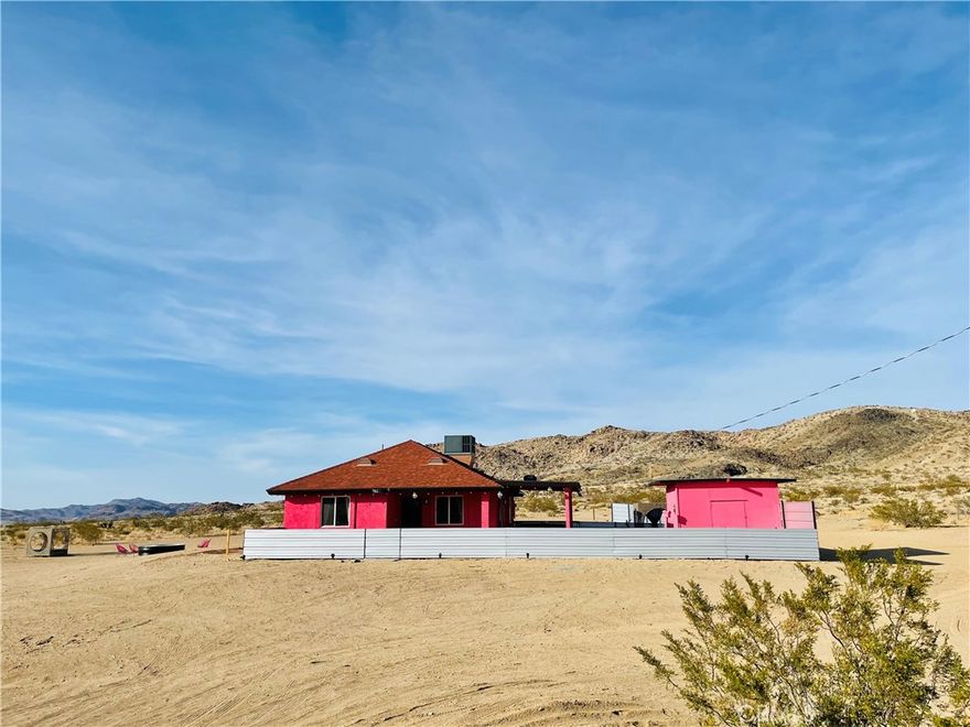 The desert getaway you’ve been dreaming of has finally hit the market! Nestled in Landers in front of Goat Mountain, this modern retreat offers captivating views and panoramic vistas that stretch for miles. Situated on a 2.5-acre lot and backing up to 490 acres of government land, it feels like having your very own 500-acre backyard! Whether you love hiking, biking, ATV adventures, or simply crave a private fortress of solitude, this is a rare opportunity you won’t want to miss.

Built in 2019, this 2 bedroom, 1 bathroom home spans almost 800 sq. ft. and is move-in ready—just bring your furniture (or offer to purchase existing). Inside, you’ll find stylish modern & sleek tile flooring throughout, and a bright living space that flows seamlessly to the outdoors through sliding glass doors.

The kitchen is fully equipped with plenty of cabinet storage, granite countertops, and appliances—including a built-in microwave, oven, and dishwasher. Both bedrooms are generously sized, each featuring textured designer wallpaper, tile floors, and large windows framing serene desert views.

Step outside to the covered patio—perfect for BBQs, outdoor dining, or cozy evenings by the fire as you watch the stunning Landers sunsets. The property also includes a garden enclosure, ideal for growing your own fruits and vegetables, plus a relaxing hot tub for stargazing nights under the endless desert sky.

Located just off a paved road, you’ll be only a mile from the world-famous Integratron and Gubler’s Orchids, and right at the base of Goat Mountain. With stars stretching for miles, this desert gem is the ultimate place to relax, recharge, and call your own.

 Arrange your private tour today and experience the magic of the Pink House in Landers! 



Buyer to verify all MLS information, including but not limited to: permits and uses, bed/bath counts, square footage, school information and enrollment availability. Buyer is advised to independently investigate all aspects of the property, and to verify the accuracy of all information provided through personal inspections and with appropriate professionals to the buyer’s satisfaction.Buyer is solely responsible for verifying water, power, zoning, and county building requirements.Buyers are responsible for confirming the accuracy of all information and are encouraged to conduct their own due diligence or retain qualified professionals.