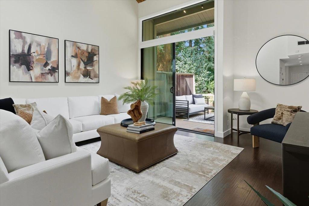 This beautifully updated 3 bedroom, 2 bath Cypress Point Villas townhome combines a tranquil setting with unbeatable convenience. Just steps from Downtown Mountain View, Caltrain, Light Rail, and Stevens Creek Trail, with easy access to Hwy 85, 237, 101, and Central Expressway. A spacious open floor plan is highlighted by wood vaulted ceilings in the living room and upstairs bedrooms, large windows, and sliders that open to the wraparound deck, creating the ideal indoor-outdoor space for entertaining or relaxing by the nearby pool. The modern kitchen features shaker cabinets, Fischer Paykel and Bosch appliances, ample counter space, a breakfast bar, and a large storage area under the staircase. A bedroom and full bath downstairs provide the perfect space for guests or a home office. Upstairs are two spacious bedrooms, a bathroom with tub and shower, laundry, and a private deck overlooking the green space. The primary bath includes a new double-sink vanity with quartz countertop and undermount sinks. Additional features include custom, stylish, and functional Hunter Douglas Smart shades with blackout in all bedrooms, central AC, new carpet and paint, covered parking conveniently adjacent to the front door, and a private storage area. Move-in ready and ready to make your home!