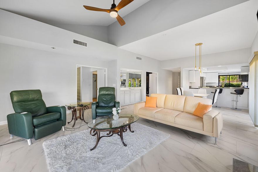 This amazingly remodeled Villa is beautifully appointed and is located on a premium interior lot at a quiet location in Ironwood.  This Villa boasts a new gourmet kitchen with granite counters and adjacent Dining area. There are newer stainless appliances along with a Washer/Dryer located in a finished double garage with extra storage.  The Living Room is generous in size and features an Italian tiled fireplace.  The high ceilings give it an expanded open feeling, and the floors are highly upgraded with simulated Carrera tile.  The front guest bedroom is large and has a private En suite bath with rain shower feature and modern smart TOTO toilet.  The Den could be used as third bedroom or an office, it looks out onto the bright landscaped atrium.  The Primary Suite is private and has an oversized closet which leads to the luxurious jacuzzi/soaking tub, a rain shower and double sink vanity featuring granite countertops.  This bathroom also features modern smart TOTO toilet.  This home is furnished with nicely appointed furnishings throughout.  The outdoor living space is amazing, large covered patio looks out onto the Western facing greenbelt and is close to the pool/spa amenities. Your membership onsite opportunities include a large Tuscan inspired Clubhouse which features a state of the art fitness center.  This Villa is an ideal choice for a short-term rental or a vacation residence.  The Ironwood Community is located just minutes from World Famous Shopping on El Paseo Dr.