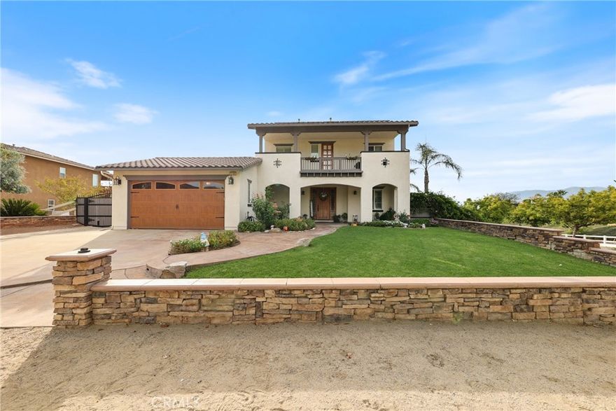 Stunning Norco Hills home! This spacious 6-bedroom, 4-bath residence offers over 3,400 sq. ft. of elegant living space with deluxe diamond-set tile, wood flooring, and shutters. The gourmet kitchen features granite counters, island with breakfast bar, and walk-in pantry. Upstairs includes a hallway desk, view deck, convenient laundry room, and multiple bedrooms, including a junior suite with private bath. The luxurious primary suite boasts breathtaking views, recessed lighting, and a spa-like bath with dual vanities, jetted tub, walk-in shower, and expansive walk-in closet. Set on nearly ½ acre, the entertainer’s backyard boasts STUNNING infinity-edge views, fresh sod, expansive patios with alumawood covers, fire pit, dual BBQ island, and lush palms. Enjoy RV parking up to 138 ft with custom gates, 3-car garage, paid-off solar panels, and an EV charger. Nestled on a quiet cul-de-sac, this home blends energy efficiency, style, and unbeatable views!