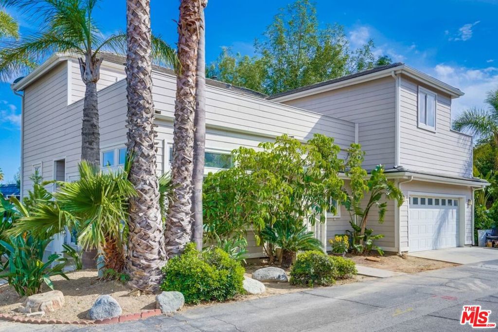 Spacious home in the desirable Top O'Topanga neighborhood - a gated community just 15 minutes to the beach and 5 minutes from schools, major shopping and all the amenities of Calabasas and Woodland Hills. This bright and airy two story home features high ceilings and multiple entertaining spaces, including large upper level decks with lovely views off of the upstairs bedrooms. The main upper deck has incredible views of the San Fernando valley and mountains as well. The floors are a combination of wood and carpet. A spacious room behind the kitchen has a fireplace and can either be used as a ground level main bedroom or den with its own separate entrance. There are 2 large bedrooms upstairs, one with an attached office/playroom and deck with treetop views. The two-car attached garage is a live/work space designed to be self contained. Palm trees, jasmine, bird of paradise and banana trees create a lush tropical curb appeal. The Top O'Topanga community has a large communal pool, spa as well and gym. The landmark mid-century clubhouse has a library, ping pong table and a billiards table making it perfect for entertaining. The community also has a dog park, car wash and children's playground as well as several hiking trails within walking distance. Agents see Private Remarks for Showing Instructions and other details.