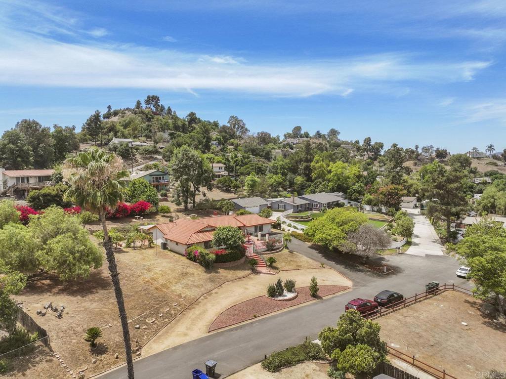 Single Story Spanish-Style home sitting on .63-acre lot and offers over 2,200 square feet of living space in one of El Cajon’s most desirable neighborhoods. Featuring an open-concept layout with multiple living areas, the home is perfect for both everyday living and entertaining. Step into a warm and inviting interior with timeless character and space to make it your own. Enjoy the tranquility of a beautifully landscaped backyard—ideal for relaxing, gardening, or expanding your vision. With no HOA and a prime location close to top-rated schools, shopping, dining, and freeway access, this property offers an ideal mix of lifestyle and long-term potential. Fantastic investment opportunity! Property includes an existing single-family home and a large lot with potential to build a new house or ADU. See draft plans provided by a County-approved engineer. Buyers to confirm all permitting, zoning, and development potential with the County building official.