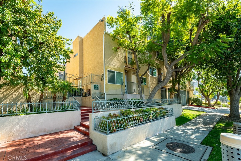 A spacious & well maintained townhouse located in a secured building. The unit features 3 Bedrooms, including a Primary Bedroom  with a large walk-in closet, and 2.5 bathrooms. This recently renovated unit has brand new laminate flooring, fresh paint throughout, brand new stove and hood, dual stainless steel sink and dishwasher. The spacious Living Room offers a gas burning fire place, recessed lighting throughout and brand new dual pane windows. The Dining room leads to a private patio for your enjoyment and barbecues. Laundry area off the kitchen with a full size washer and dryer. Plenty of storage inside the unit. Two, assigned,  side-by-side Subterranean Parking spaces.