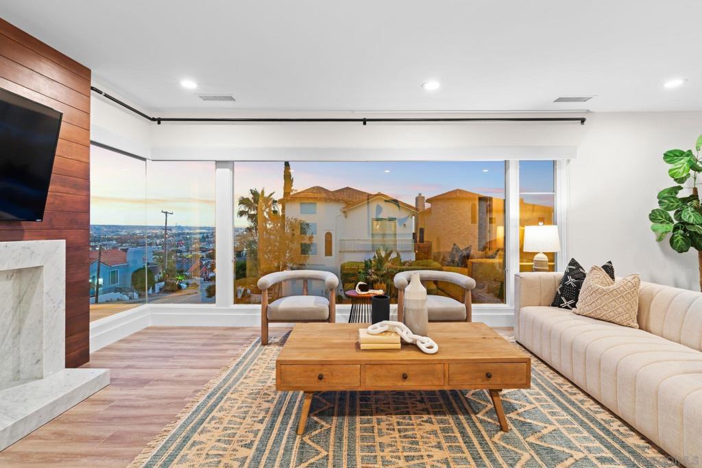 BACK ON THE MARKET WITH EXCITING NEW RENOVATIONS! Get ready to fall in love again—this stunning modern|classic home in the heart of Point Loma is BACK & BETTER THAN EVER! Perched proudly on a scenic corner lot, this radiant home has been elevated with brand-new upgrades that take coastal living to a whole new level! NEW REMODEL INCLUDES: * A GORGEOUS KITCHEN ISLAND with waterfall-edge Quartzite countertops. *SUITE DOWNSTAIRS IS NOW COMPLETE WITH A NEW KITCHENETTE—fully loaded with a fridge, microwave, ample cabinet space and cooktop allowing endless possibilities to convert the suite into a guest house, theater room, game room or the option to lease a fully equipped guest house with it's own separate entrance. Step out onto your NEW EXPANSIVE WOOD DECK and soak in the unforgettable VIEWS OF SAN DIEGO BAY, the glittering skyline, and distant mountain peaks. Then step inside to find floor-to-ceiling windows that bring those epic views right into your living room! INSIDE, you’ll find nothing but top-tier luxury and comfort, including: *A show stopping chef’s kitchen with pro-grade appliances. *A fully remodeled primary suite with marble tile and dual sinks *A chic, NEW powder room with marble floors and timeless wainscoting *The epoxy-coated 3-car garage comes with a Tesla charging station. THE BACKYARD-THE MAGIC CONTINUES WITH: *A yard large enough for a POOL! *An epic deck made for sunset cocktails, large enough to build an ANOTHER adu or just enjoy with seating for weekend BBQ's & a glass of wine. IF YOU LOVE LUXURY, VIEWS & COMFORT- THIS IS A MUST SEE!