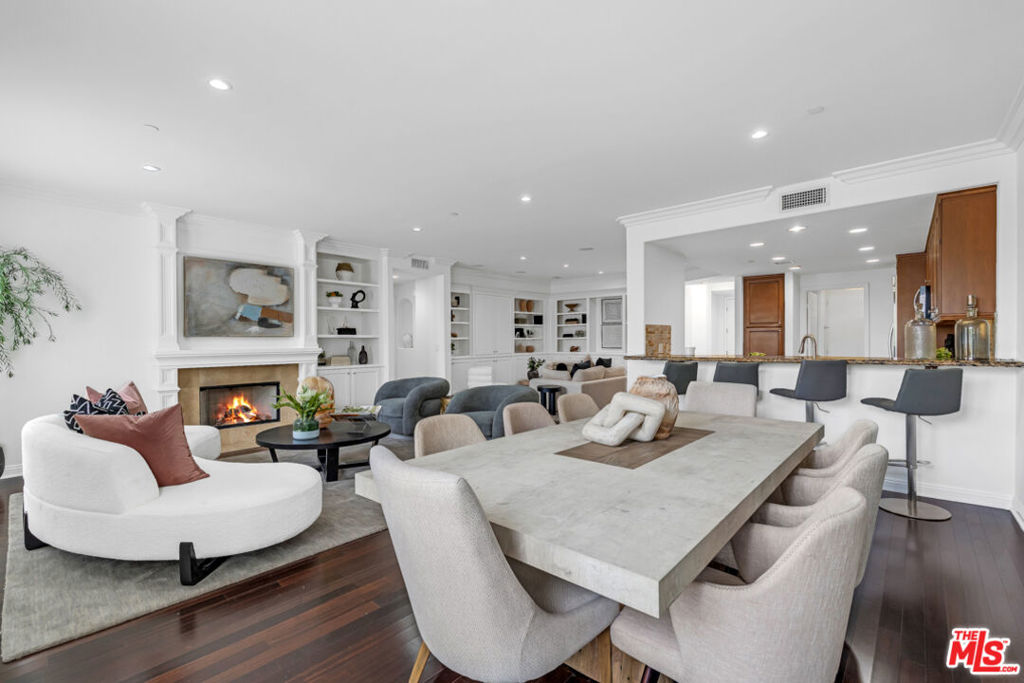 Experience elevated living in this stunning, west-facing penthouse located in the heart of Beverly Hills proper. Bathed in natural light and featuring high ceilings, Residence 304 offers an expansive open floor plan that seamlessly provides family room space, dining room, and living room. Step inside to find a skylight welcoming entry foyer. The gourmet kitchen boasts marble countertops, new stainless steel appliances, and ample custom cabinetry, perfect for both entertaining and everyday living. The living area features elegant built-in cabinets and rich hardwood flooring, while integrated sound speakers connects easily through bluetooth. The spacious primary suite is a true retreat, complete with a cozy fireplace, a generous walk-in closet, and a luxurious en-suite bathroom featuring dual sinks, a vanity, and a separate soaking tub and shower. The guest bedroom also includes its own en-suite bathroom. Nestled in the prestigious Beverly Hills School District and just moments from world-class dining, shopping, and entertainment, this penthouse offers the best of Beverly Hills living.