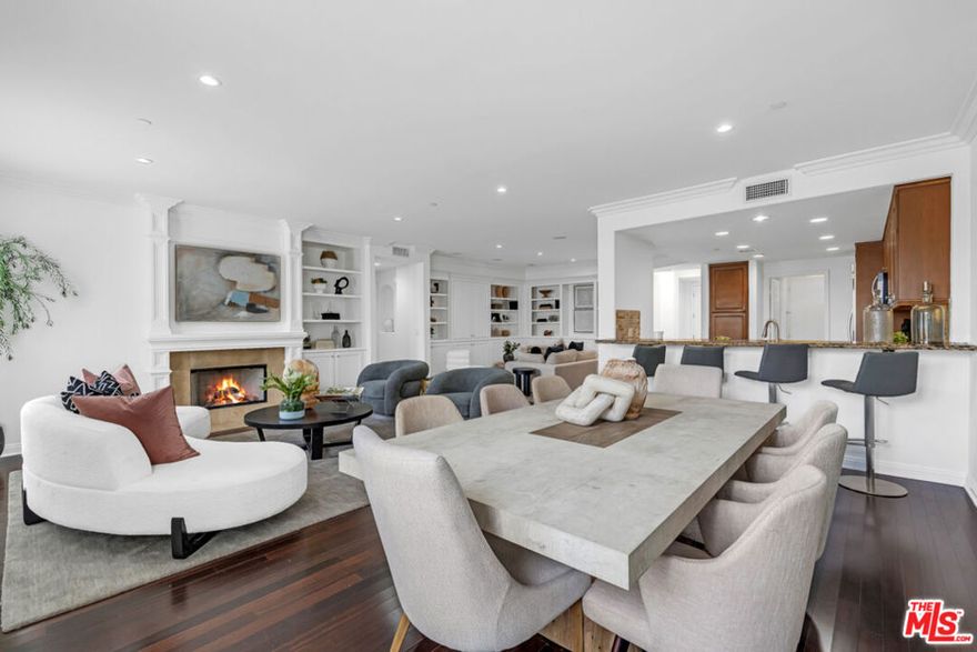 Experience elevated living in this stunning, west-facing penthouse located in the heart of Beverly Hills proper. Bathed in natural light and featuring high ceilings, Residence 304 offers an expansive open floor plan that seamlessly provides family room space, dining room, and living room. Step inside to find a skylight welcoming entry foyer. The gourmet kitchen boasts marble countertops, new stainless steel appliances, and ample custom cabinetry, perfect for both entertaining and everyday living. The living area features elegant built-in cabinets and rich hardwood flooring, while integrated sound speakers connects easily through bluetooth. The spacious primary suite is a true retreat, complete with a cozy fireplace, a generous walk-in closet, and a luxurious en-suite bathroom featuring dual sinks, a vanity, and a separate soaking tub and shower. The guest bedroom also includes its own en-suite bathroom. Nestled in the prestigious Beverly Hills School District and just moments from world-class dining, shopping, and entertainment, this penthouse offers the best of Beverly Hills living.