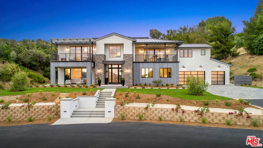 Nestled within the scenic rolling hills of Calabasas, this exquisite modern farmhouse redefines luxury living. Spanning over 2 acres of lush, flourishing land, this estate seamlessly blends contemporary elegance with natural beauty, offering an unforgettable retreat. From the moment you step into the striking foyer, you're  captivated by the soaring volume ceilings, an abundance of natural light pouring through expansive windows, and the warmth of wide-plank white oak floors that flow throughout the home. The formal living room exudes sophistication, while the superb office space and inviting great room are anchored by a sleek, modern fireplace. The state-of-the-art kitchen is a chef's dream, boasting top-of-the-line Thermador appliances, a subway tile backsplash, shiplap accent walls, and a butler's pantry that conveniently opens to the outdoors; perfect for effortless year-round al fresco dining. Upstairs, discover three generously sized en-suite bedrooms and a versatile bonus room with an attached balcony. The primary suite is a true sanctuary, offering breathtaking views of the surrounding hills. The spa-inspired master bath features dual walk-in closets, a soaking tub, and a stunning double-sided shower that epitomizes luxury. The rear grounds are an entertainer's paradise, complete with a cabana featuring a private bathroom, an outdoor grill station, and a sparkling pool and spa. Whether hosting gatherings or enjoying quiet evenings under the stars, this property is designed for seamless indoor-outdoor living at its finest. Now also available for lease at $35,000 per month.