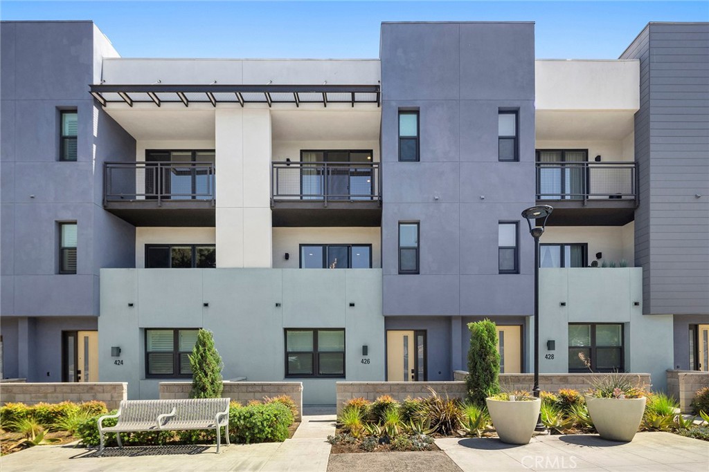 Welcome to 426 W Central Ave, a stunning 3-story townhouse in the heart of Brea’s desirable West Village by Trumark Homes. This modern 2,200 sq. ft. residence, built in 2020, offers 3 bedrooms and 3.5 bathrooms, blending contemporary design with functional living spaces.
Step inside to discover an open-concept layout featuring a gourmet kitchen with a large quartz island, stainless steel appliances, and ample storage, perfect for culinary enthusiasts. The spacious living and dining areas flow seamlessly, ideal for entertaining, with stylish tile and laminate flooring throughout. Upgrades include dual-paned windows, a tankless water heater, electric car charger, split A/C units in each room and owned solar panel energy.
The first floor includes an additional versatile (4th) bedroom with an en-suite bathroom, perfect for guests or a home office. The second floor boasts an airy living space with abundant natural light, while the third-floor primary suite offers a walk-in closet and a luxurious dual-sink vanity. A 2-car side-by-side attached garage provides additional storage and convenience.
Nestled in a vibrant community, this home is steps away from a private park, playground, and splash pad, ideal for families. Located in the top-rated Brea-Olinda Unified School District, it’s minutes from William E. Fanning Elementary, Brea Junior High, and local favorites like Vons, Starbucks, and Downtown Brea’s dining and shopping. With easy freeway access, this home combines suburban tranquility with urban connectivity.
Don’t miss this opportunity to own a beautifully upgraded townhome in one of Brea’s most sought-after neighborhoods. Schedule your tour today!