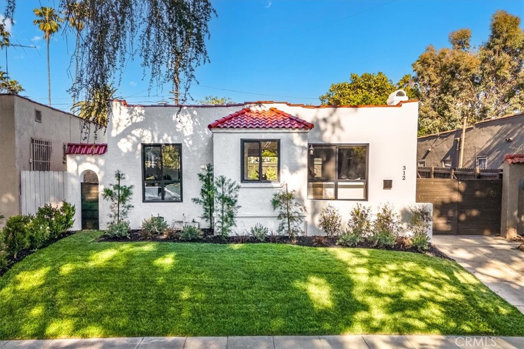 Welcome to this stunningly transformed Spanish Revival home in the heart of hottest neighborhoods in LA - Larchmont Village. , where timeless character meets modern upgrades. This thoughtfully reimagined property offers warm, inviting spaces… Step into a front yard adorned with new sod and carefully selected plants, setting the stage for the serene retreat that lies beyond. The rear yard is framed by lush hedges, creating a private oasis perfect for entertaining or relaxing. A long driveway adds extra off street parking. Inside, the light-filled living and dining areas feature natural light streaming through new dual-glazed, low-e windows. New LVP hardwood floors anchor the open-concept spaces, while all new fixtures add a curated sense of style. The custom kitchen is both beautiful and functional, with marble like quartz countertops, a statement tile backsplash, and self-closing cabinetry. Stainless steel appliances, including a gas range, dishwasher, and large kitchen island make this space a dream for cooking and entertaining. The conveniently placed laundry room off the kitchen ensures everyday tasks are effortless with additional cabinet for extra storage. The two bedrooms are light and bright and offer a relaxing place to unwind at the end our our day. The remodeled bathroom features sophisticated tilework,, blending artistic design with modern luxury. Extensive system upgrades ensure this home is as functional as it is beautiful. A new HVAC system and new ducting ensures year-round comfort. The home also boasts updated plumbing, including a new tankless water heater, and updated wiring. The 2 car detached garage can be converted into a versatile flex space. Whether it becomes your creative studio, or gym, this additional space is ready to adapt to your lifestyle. Situated near some of the best dining and shopping in Los Angeles, this home offers not only architectural charm but also close proximity to vibrant community hotspots. This revived Spanish gem invites you to enjoy the perfect blend of historic character and modern convenience, all within one of LA's most beloved neighborhoods.